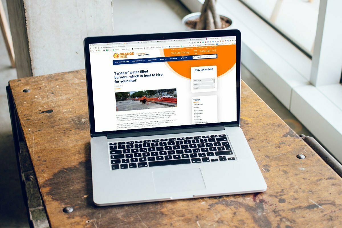 Laptop open showing Orange Hire website